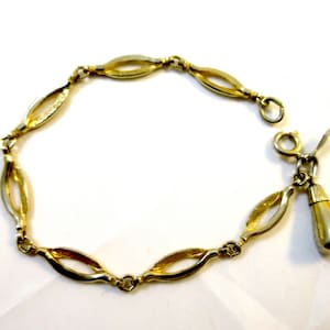 Bracelet à maillons dorés avec breloque en perles d&#39;or « Charmant » signé Sarah Coventry Bracelet à maillons ovales avec breloque MidCentury vintage 1964, bijoux fantaisie
