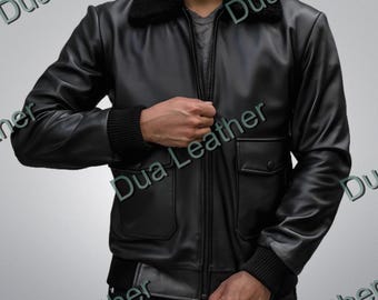 May include: Black leather jacket with a black faux fur collar, a zip-up front, and two front pockets. The jacket has ribbed cuffs and a ribbed hem. The jacket is a classic bomber style.