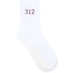 May include: White athletic sock with the number "312" embroidered in purple on the cuff. The sole features a pattern of small, light-colored dots. The sock is made of a ribbed knit material.