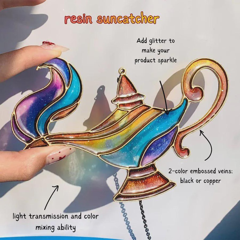 May include: A resin suncatcher shaped like a genie lamp with a multi-colored gradient finish including blue, purple, orange, and yellow hues. The design features metallic outlines, glitter accents, and text labels describing light transmission and veins.