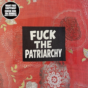 May include: Black rectangular patch with the text "FUCK THE PATRIARCHY" in white, set against a red patterned background. A circular graphic in the upper left corner contains text.