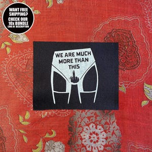 Puede incluir: Parche negro con gráfico blanco de ropa interior y dedo medio, el texto dice "WE ARE MUCH MORE THAN THIS". Un gráfico circular en la esquina superior izquierda dice "WANT FREE SHIPPING? CHECK OUR 10X BUNDLE LINK IN DESCRIPTION".