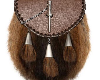 May include: A brown leather sporran with a fur body and silver metal accents. The sporran features a flap closure, a chain, and three decorative tassels. The leather is a textured brown, and the fur is a mix of brown and tan.