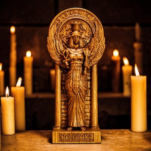 May include: A golden statue of Nefertys, with a winged sun disc, stands centered, surrounded by lit candles. The statue is intricately detailed, with hieroglyphs at the base. The warm lighting creates a mystical ambiance, highlighting the statue's features and the flickering flames.