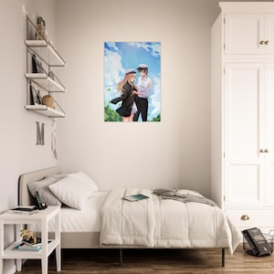 May include: A framed art print showing an anime-style illustration of a couple. The artwork depicts a man and woman in formal attire, set against a backdrop of a blue sky with clouds and green foliage. The couple is standing close together.