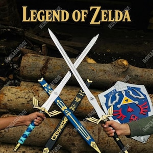 May include: An image featuring swords and a shield with a blue and gold design, inspired by the Legend of Zelda. The swords are silver with gold accents and blue handles. The shield is blue with a red and yellow emblem. The text "LEGEND OF ZELDA" is at the top.