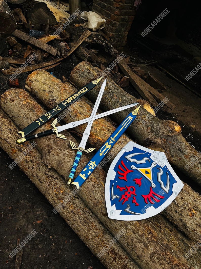 May include: A collection of fantasy swords and a shield, resting on wooden logs. The swords have silver blades and ornate handles, with black, blue, and gold accents. The shield is blue with a red emblem and a yellow triangle.