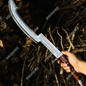 May include: A curved, silver-colored blade with a decorative etched design and star accents. The handle is made of dark wood with a silver-colored metal guard. The text "IRONSAGAFORGE" is visible on the blade.