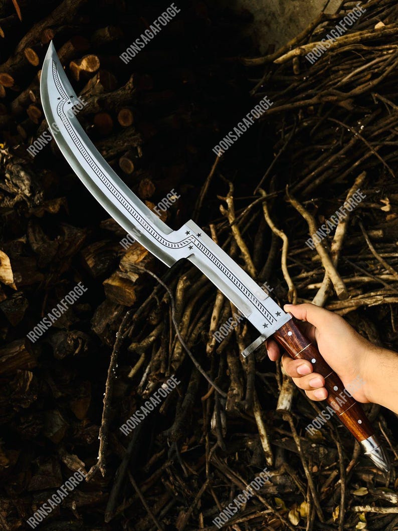 May include: A curved, silver-colored blade with a decorative etched design and star accents. The handle is made of dark wood with a silver-colored metal guard. The text "IRONSAGAFORGE" is visible on the blade.