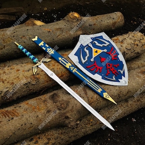 May include: A sword, scabbard, and shield set. The sword has a silver blade and blue handle. The scabbard is blue with gold accents. The shield is blue with red and yellow details. The items are displayed on a wooden surface.