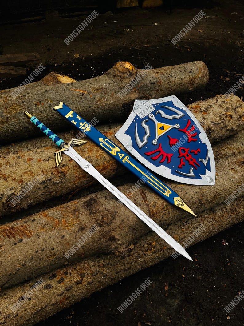 May include: A sword, scabbard, and shield set. The sword has a silver blade and blue handle. The scabbard is blue with gold accents. The shield is blue with red and yellow details. The items are displayed on a wooden surface.