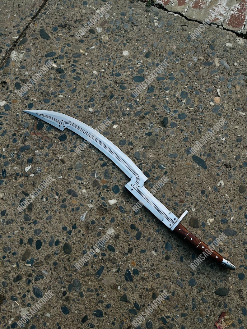 May include: A curved, silver-colored blade with a wooden handle. The blade has a decorative design along the spine and is marked with the text "IRONSAGAFORGE". The handle is dark brown with silver accents.
