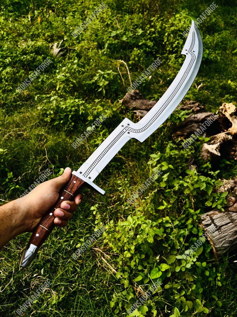 May include: A curved, silver-colored sword with a wooden handle. The blade has a decorative pattern along the spine and a star design near the hilt. The handle is dark brown with silver accents.