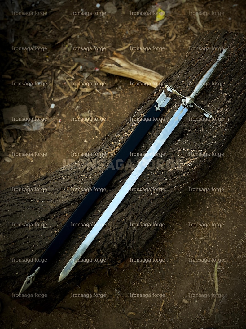 May include: A long, silver sword with a cross-shaped hilt and a black sheath rests on a weathered log. The sword's blade is polished, reflecting light. The text "Ironsaga forge" is visible in the image.