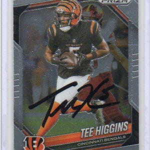 May include: A Panini Prizm trading card featuring an action photograph of football player Tee Higgins in a black and orange Cincinnati Bengals uniform, holding a football. The card includes a black ink autograph and the text Tee Higgins Cincinnati Bengals.