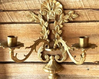 Vintage ornate cast brass decorative two candle wall sconce.