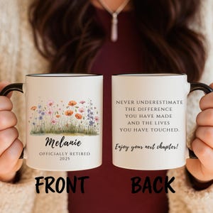 May include: A white ceramic mug with a black handle and rim. The front features a floral design with the name "Melanie" and the text "OFFICIALLY RETIRED 2025". The back has the text "NEVER UNDERESTIMATE THE DIFFERENCE YOU HAVE MADE" and "Enjoy your next chapter!"