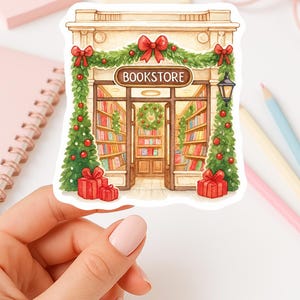 May include: A sticker depicting a festive bookstore. The illustration shows a bookstore entrance decorated with garlands, red bows, and Christmas trees. The word "BOOKSTORE" is displayed above the entrance, with red gift boxes at the base.