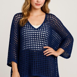May include: A navy blue crochet top with a loose fit and a v-neck. The top has a grid pattern and is made of a lightweight material.