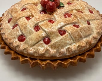 Vintage ceramic cherry pie plate with decorative lid.