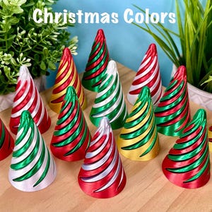 May include: A collection of cone-shaped ornaments featuring spiral ridges in various metallic color combinations including red, green, silver, and gold. The text "Christmas Colors" is displayed at the top of the image above the ornaments.