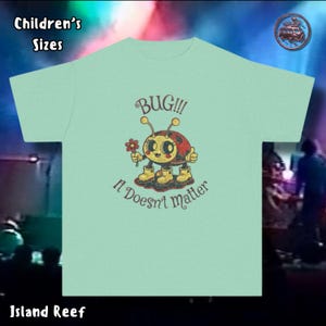 May include: A light green children's t-shirt featuring a cartoon bug character holding a flower. The text "BUG!!! It Doesn't matter" is printed on the shirt. The words "Children's Sizes" and "Island Reef" are also visible.