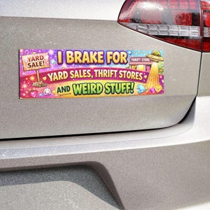 May include: A rectangular bumper magnet featuring a vibrant purple and pink background with sparkles. The text reads I BRAKE FOR YARD SALES, THRIFT STORES AND WEIRD STUFF! It includes illustrations of a yard sale sign, a UFO, and various gems.