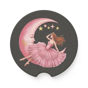 May include: A pink crescent moon with a sleeping woman in a pink dress and a crown of stars above her. The background is black.