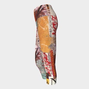 May include: Abstract patterned leggings featuring a collage of textures and colors. The design incorporates elements of sheet music, splattered paint, and various paper textures in shades of brown, red, and beige. The leggings are knee-length.