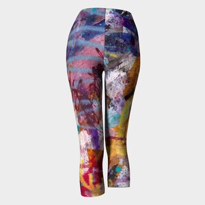 Colorful abstract print leggings with a cropped length. The leggings have a blue, pink, yellow, green, and purple color scheme with a paint splatter design.