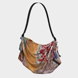 May include: A shoulder bag with a black strap and a colorful abstract design. The bag features a mix of orange, red, and blue hues, with musical notes and paint splatters. The bag's design is artistic and unique.