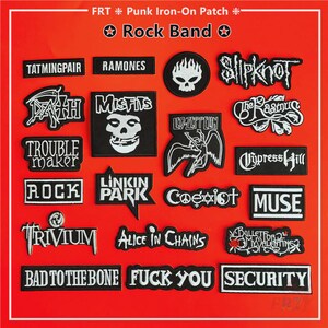 May include: A selection of black and white iron-on patches showcasing logos and names of rock bands such as "Misfits," "Led Zeppelin," and "Slipknot." The patches are presented against a red backdrop, with the words "Rock Band" displayed at the top.