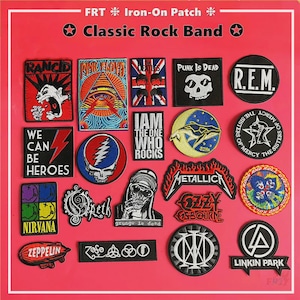 May include: A selection of iron-on patches displaying logos of classic rock bands. Patches include bands such as Metallica, Nirvana, and Linkin Park, with phrases like "Punk is Dead" and "We Can Be Heroes". The background is a solid red.