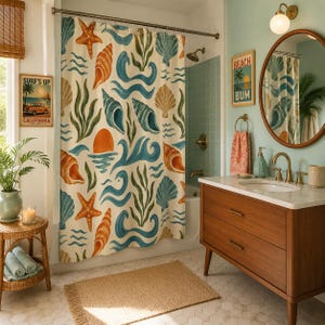 May include: A coastal-themed bathroom with a shower curtain featuring a watercolor design of seashells, waves, and sea plants in shades of blue, orange, and green. A wooden vanity, round mirror, and a "Beach Bum" sign complete the decor.