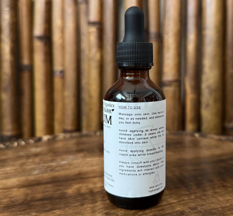 May include: A brown glass bottle with a black dropper top. The bottle has a white label with black text, including "HOW TO USE" and product information. The bottle is filled with a dark liquid.