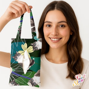 May include: A tote bag with a repeating pattern of grey and white cats on a teal and green background with yellow floral accents. The bag has a white tissue dispenser and the text "Fa meet Meow" in the lower right corner.