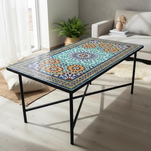 May include: A rectangular coffee table featuring a mosaic tile top with intricate geometric patterns in shades of teal, yellow, orange, and dark blue. The table is supported by a simple black metal frame with four thin legs and cross-bracing.