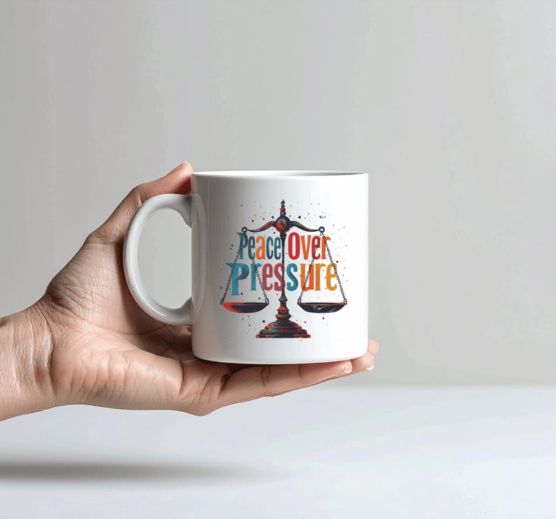 May include: A white ceramic mug with a black handle and the text "But First, Coffee" in a black, handwritten-style font. The mug is on a white surface.