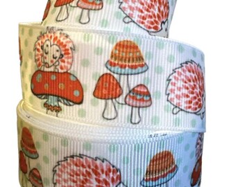 May include: White ribbon with a repeating pattern of red and brown hedgehogs and mushrooms. The ribbon has a green polka dot background.