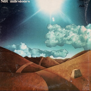 May include: Album cover for "SRC Milestones" featuring a landscape with brown hills, a winding road, and a cloudy sky. The sun shines brightly above the clouds. The album title is at the top left, and the band's name is on a stone marker.