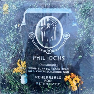 May include: A black and white photo of Phil Ochs on a vinyl record cover. The photo shows him holding a rifle and wearing a hat with an American flag. The text on the cover reads "Phil Ochs (American) Born: El Paso, Texas 1940 Died: Chicago, Illinois 1968 Rehearsals for Retirement."