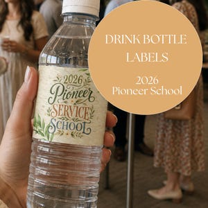 May include: A clear plastic water bottle featuring a decorative label with the text 2026 Pioneer Service School in green, brown, and blue script and serif fonts, accented by illustrations of green leaves and small white flowers on a cream background.