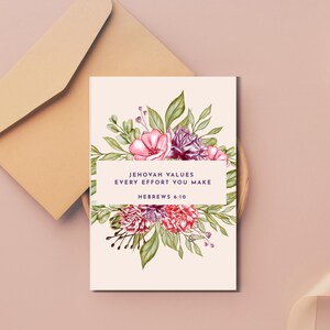 May include: A greeting card with a floral design and the text "JEHOVAH VALUES EVERY EFFORT YOU MAKE HEBREWS 6:10". The card features pink, red, and purple flowers with green leaves. A beige envelope is in the background.