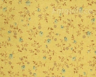 May include: Yellow fabric with a floral pattern. The design features small blue flowers and brown stems and leaves. The fabric has a textured appearance and a ruler is at the bottom of the image.