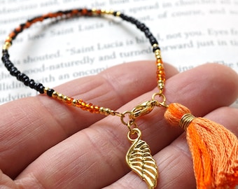 ON VACATION, Two tone Black Orange Tassel Bracelet Thin Gold Beaded Angel Wing Charm Friendship Bracelet Tiny Seed Bead Minimal