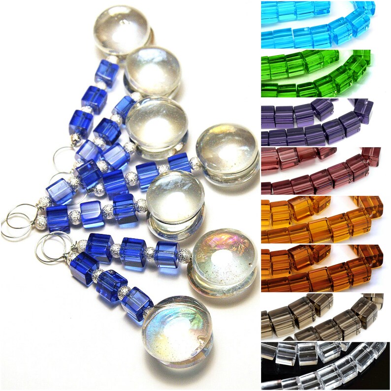 May include: An assortment of colorful beads and charms. The image features strands of blue cube beads and clear, iridescent glass charms. Additional strands of colorful cube beads in shades of blue, green, purple, red, orange, brown, and gray are also shown.