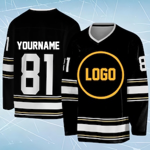 May include: A black hockey jersey featuring a white V-neck collar, white and gold stripes on the sleeves and hem, and the number 81 in white on the back. The back displays the text YOURNAME, while the front features a yellow circular logo graphic.