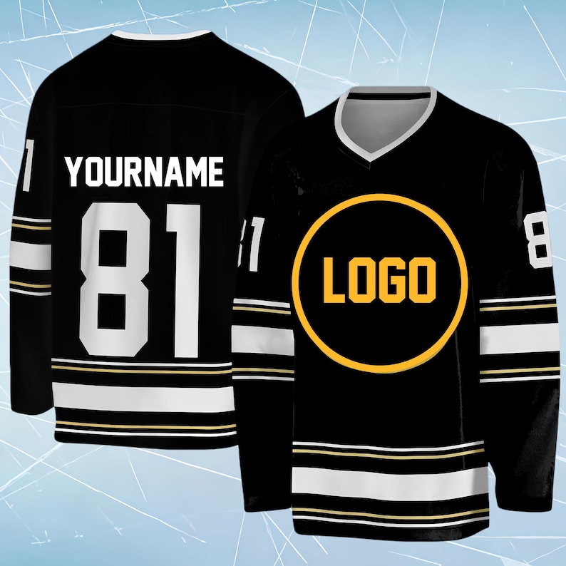 May include: A black hockey jersey featuring a white V-neck collar, white and gold stripes on the sleeves and hem, and the number 81 in white on the back. The back displays the text YOURNAME, while the front features a yellow circular logo graphic.