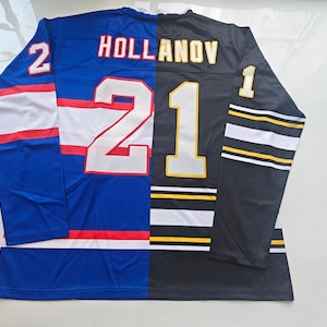 May include: A split-design hockey jersey featuring a blue left side with white and red stripes and a black right side with white and yellow stripes. The back displays the text HOLLANOV with the number 21, plus the number 2 on the left sleeve and 1 on the right sleeve.