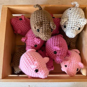 May include: A white ceramic mug with a black handle and the text "But First, Coffee" in a bold, black font. The mug is set against a neutral background, highlighting its simple design.